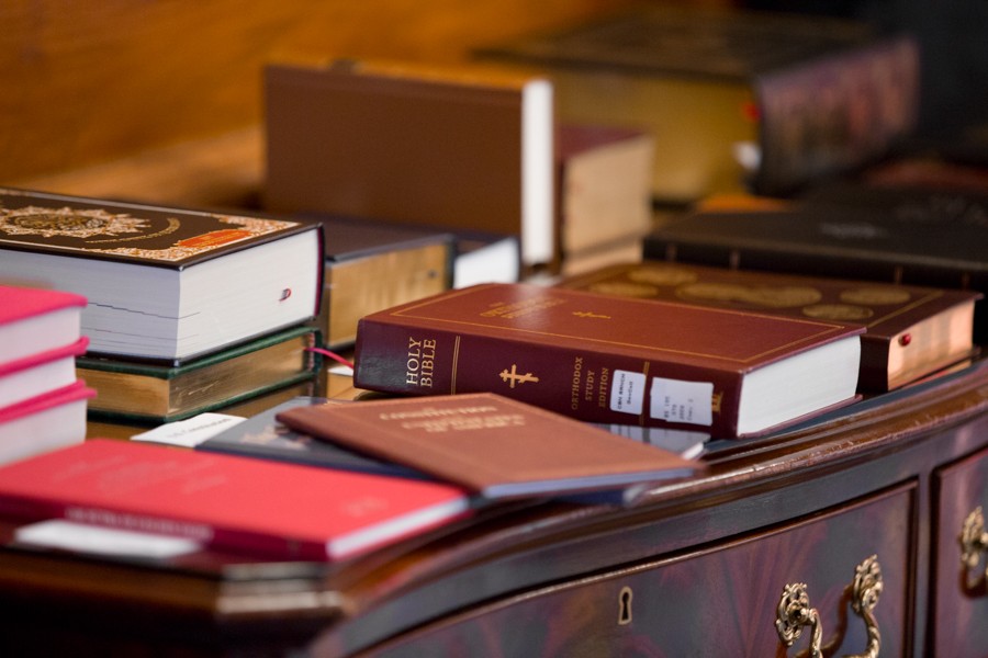 Bibles line the table adjacent to the staging area for the ceremonial swearing in. - Erik Paul Howard