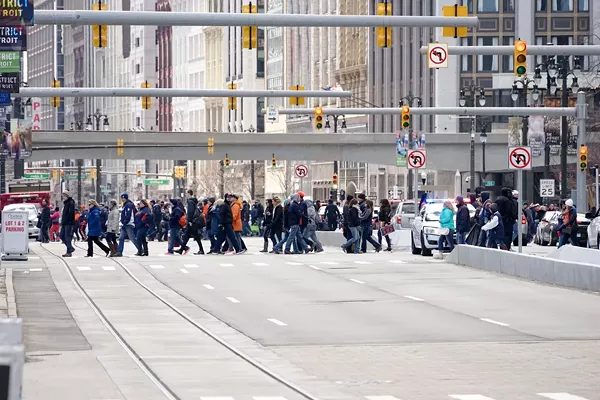 A crowd of pedestrians crossing Woodward Ave. in downtown Detroit. - Tony Bennett/Detroit Stock City