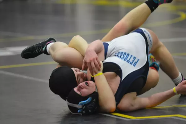Cutline: Fenton High School senior Chloe Wagner tries to pin Petoskey's Lydia Krauss in the 140-pound final at the first-ever Michigan Wrestling Association girls state championship on Sunday, Feb. 3 at Adrian College. - Dominic Adams