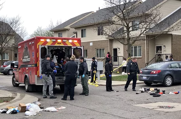 Medics place the shooting victim in an ambulance at the Brewster housing complex. - Steve Neavling