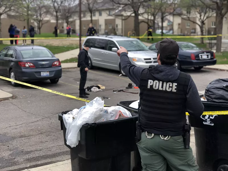 Police cordoned off the shooting scene in the parking lot of the Brewster housing complex. - Steve Neavling