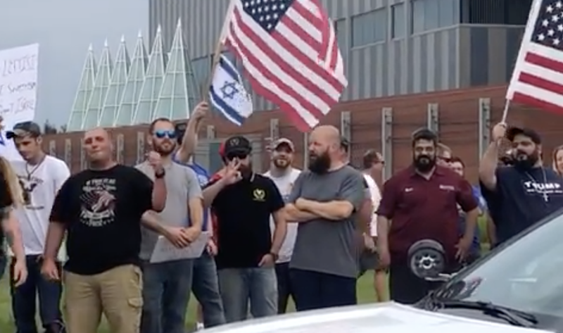 A man flashes a white power symbol in front of Farmington Hills' Holocaust Memorial Center. - Mark Adler