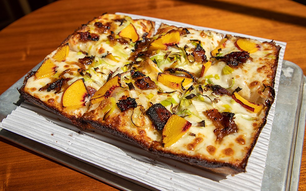 A new spin on an old classic: The Peach Pit from Michigan & Trumbull features peaches, leeks, bacon jam, and honey drizzle. - Bridget Ekis
