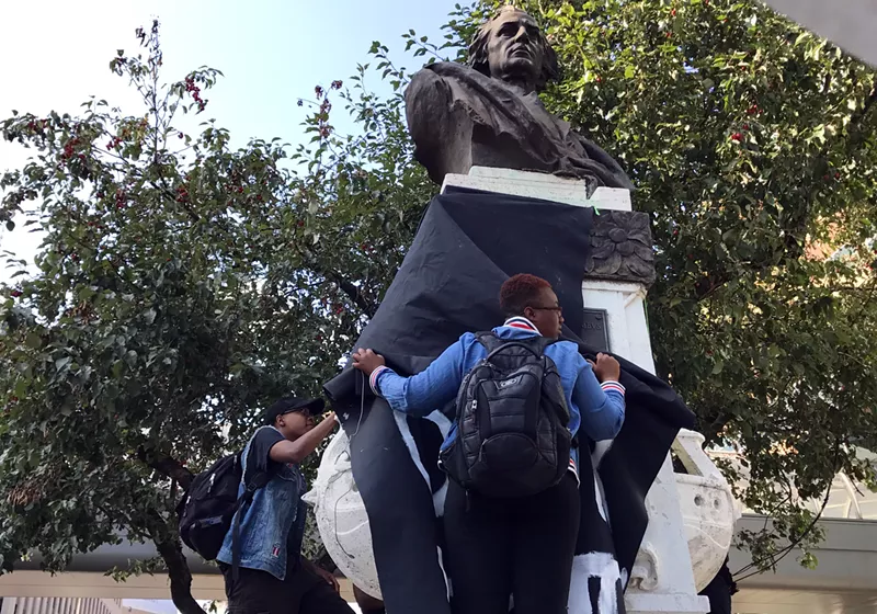 Protesters draped a black cloth over the Christopher Columbus statue in downtown Detroit in 2017. - By Steve Neavling