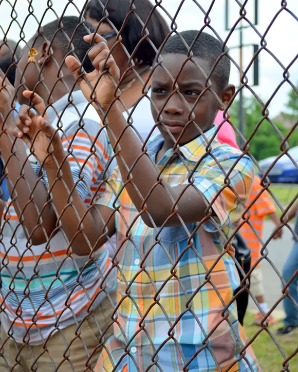 Jordan Brooks, 8, visited the shooting scene at Dexter and Webb on Sunday with his grandmother. Brooks' father was at the basketball court Saturday, but left before the shooting. "I was scared that my dad probably got shot," Brooks said. - Courtesy of Dustin Blitchok