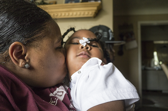 Robertson and her daughter Kyi'Lei hang out in their living room. - Iain Maitland