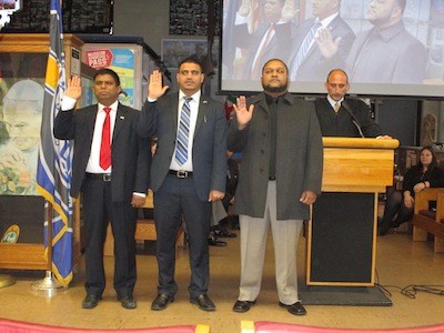 Left to right: Abu Musa, Saad Almasmari, and Anam Miah are sworn in by Judge Paul J. Paruk.