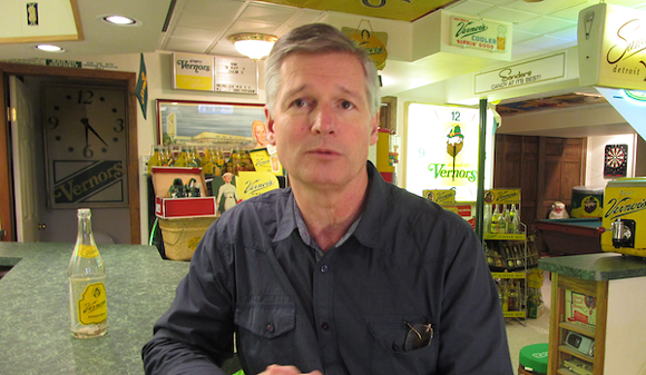 Keith Wunderlich sits at the soda fountain in the small museum he's built in his basement.