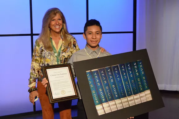 Pictures of Hope founder Linda Solomon with 13-year-old Cesar Chavez MIddle School student Cristian Luz-Gutierrez during a reception Thursday at WXYZ-TV. - Photo by Dustin Blitchok.