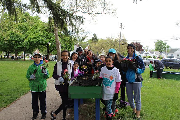 Volunteers plant flowers for community garden. - photo credit: National Network for Arab American Communities