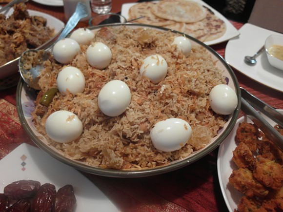 Biryani, loaded with chicken quarters, pineapple, and topped with hard boiled eggs. - PHOTO BY SERENA MARIA DANIELS