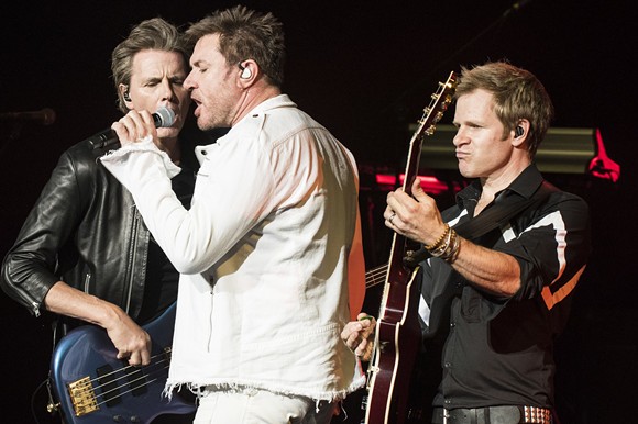 Duran Duran's John Taylor, left, Simon Le Bon, and Dom Brown onstage at DTE Energy Music Theatre on Monday. - PHOTO BY MIKE FERDINANDE