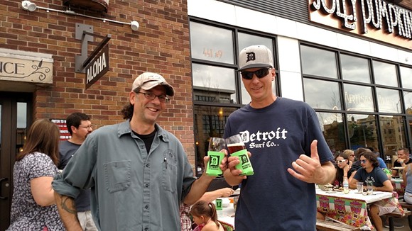 Ron Jeffries, Jolly Pumpkin Artisan Ales founder and brewmaster, and Dave Tuzinowski, owner of Detroit Surf Co., raise a glass of Detroit Surf Co. Pale Ale raise a glass of special collaborative brew Detroit Surf Co. Pale Ale.
