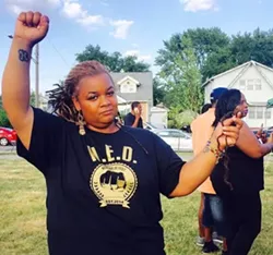 Mikera Manning, 34, holds up strands of hair she says police pulled out during her arrest June 7. - Photo by Allie Gross