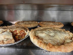 Savory pies baking in the oven at a popup event at St. CeCe's Pub. - Photo by Serena Maria Daniels
