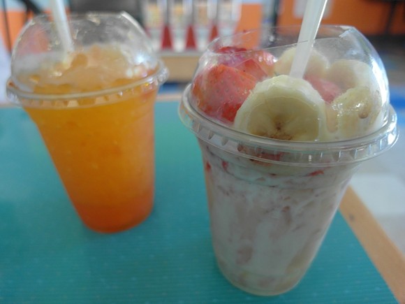 A raspado shaved ice (left) and La Gloria, featuring strawberries, banana, shaved ice and cream.
