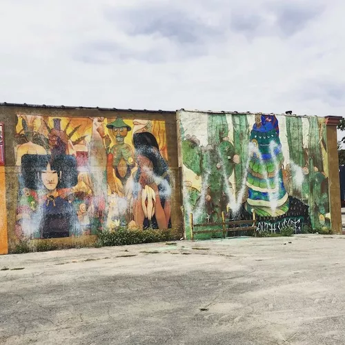 The mural was apparently defaced with white spray paint. - Photo taken from Lee DeVito's Facebook page
