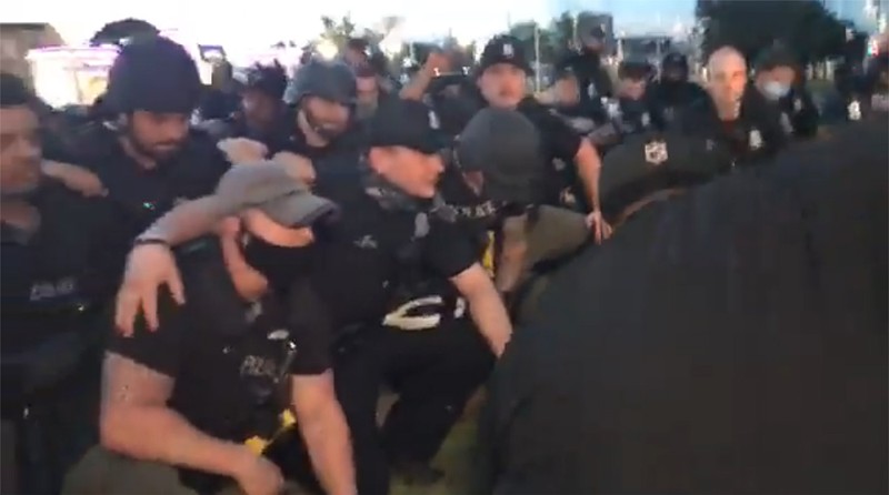 Detroit Police kneeled for the cameras minutes after arresting about 100 peaceful protesters
