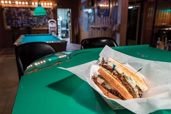 Even late at night, Royal Oak’s Ye Olde Saloon serves this “slappin’” brisket sandwich: two slices of Texas toast, grilled; brisket, brined, braised, and chopped; pickles, horseradish sauce, and cheese. - Photo by Jacob Lewkow.