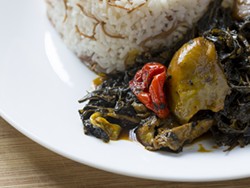 Molokhia (jute leaf) with red palm oil and pepper served with jasmine rice. - Photo by Jacob Lewkow.