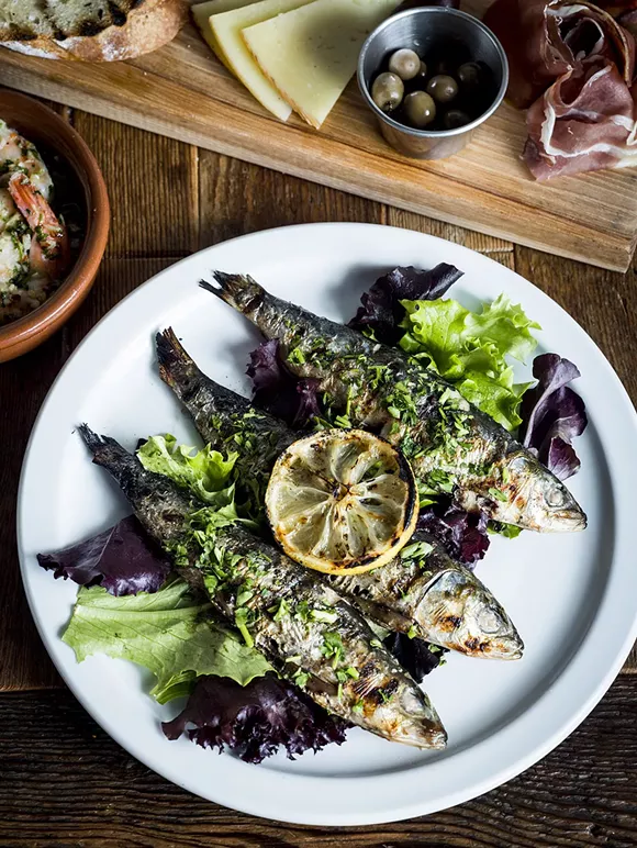Sardinas Asadas – grilled fresh sardines, with grilled lemon, and tarragon at La Feria in the Cass Corridor. - © Joe Vaughn