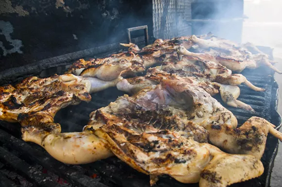 Birds splayed on the grill at Southwest Detroit's Pollos Los Gallos. - Photo by Tom Perkins