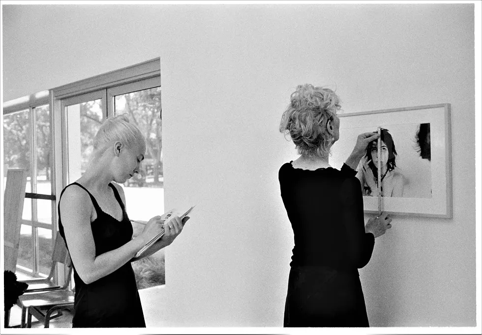 Gallery director Hazel Blake (at left) installs an exhibition by artist Judy Linn with Susanne Hilberry (right), 2008. - Judy Linn