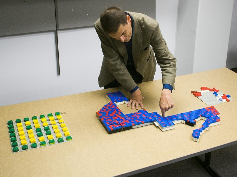 Wayne State University associate political science professor Kevin Deegan-Krause uses Legos to demonstrate gerrymandering. The zig-zag shape is Michigan's 14th Congressional District. - TOM PERKINS