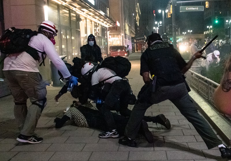 Police use a baton during an Aug. 23 protest in Detroit. - Attorneys for Detroit Will Breathe