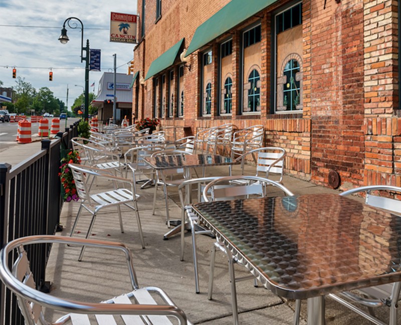 View of outside patio furniture for the Cancun Mexican Grill and the Grand Loft business at the corner of Bridge Street and Jefferson in Grand Ledge. - Focused Adventures / Shutterstock.com