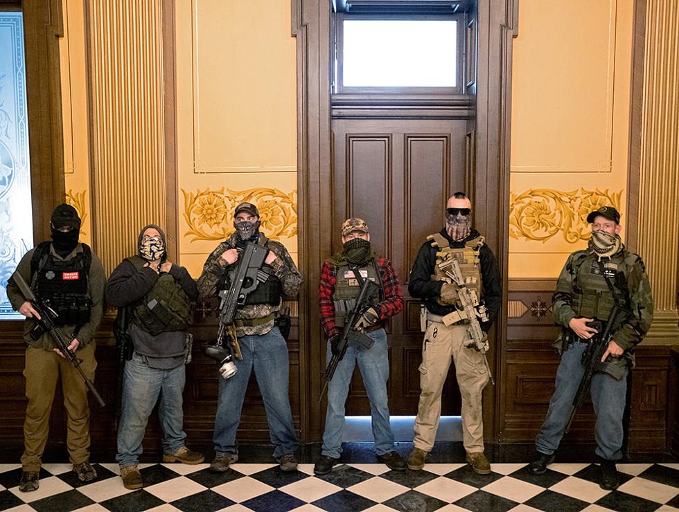 Protesters occupied the Michigan state capitol building on April 30, 2020. Three men were later identified by a Washington Post analysis as (from right) Pete Musico, Paul Bellar, and Joseph Morrison. - REUTERS/SETH HERALD
