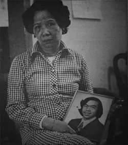 Lily Chin holds a picture of her son, Vincent. - Helen Zia