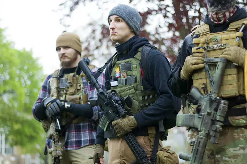 Armed protesters at a rally against Michigan's COVID-19 restrictions in May 2020. - By Steve Neavling