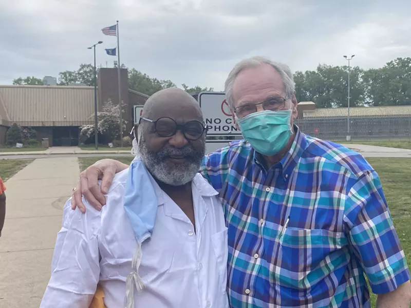 Ray Gray celebrates his freedom in Muskegon Tuesday with Humanity for Prisoners founder Doug Tjapkes. - Dave Mesrey