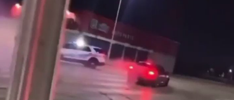 A Dodge Charger does doughnuts around a DPD car. - Screenshot