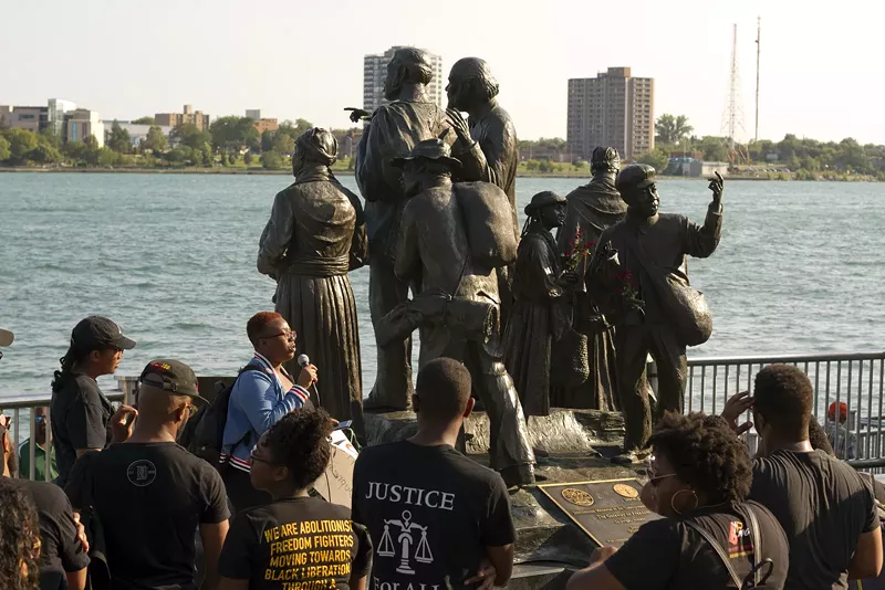 Black activists rally against racism next to an Underground Railroad monument in Hart Plaza in Detroit. - Steve Neavling