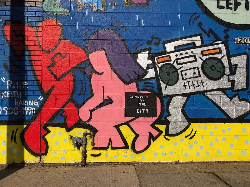 A mural by Detroit artist Sheefy McFly was modified after someone complained about one of the figures' butts. - Lee DeVito