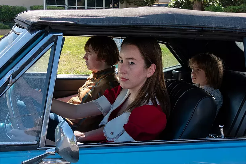 Alana Haim, center, and Cooper Hoffman, left, in Paul Thomas Anderson’s Licorice Pizza.