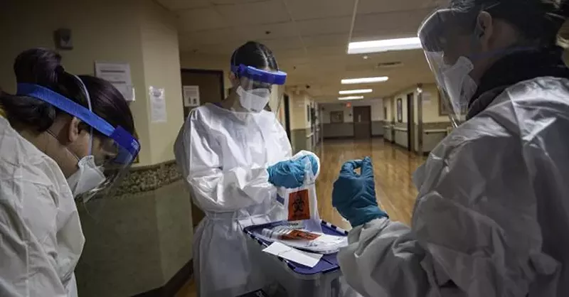 A team of volunteers prepares swabs to test residents in a facility in Detroit. - Centers for Disease Control and Prevention