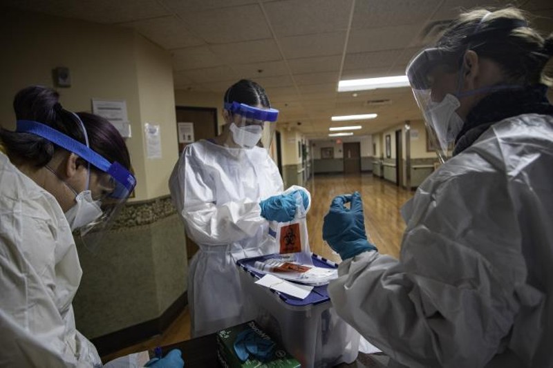 A team of volunteers prepares swabs to test residents in a facility in Detroit. - Centers for Disease Control and Prevention
