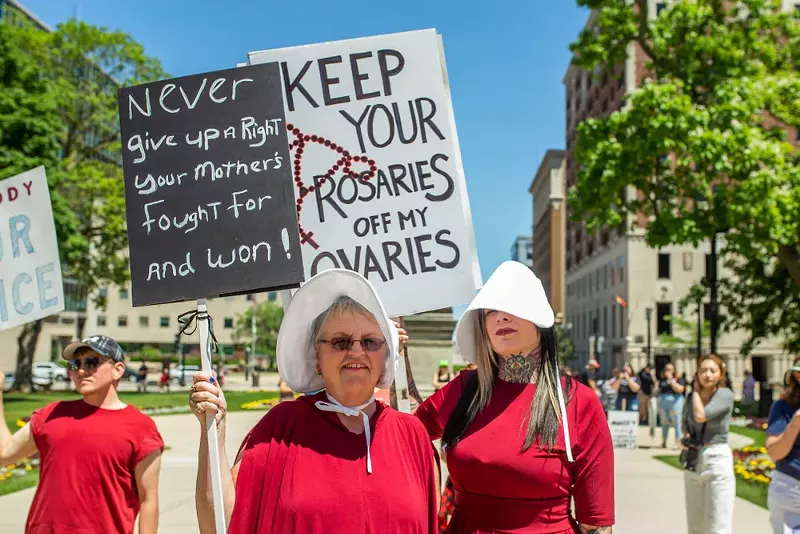 Pro-choice protesters in Lansing dressed as characters from The Handmaid's Tale. - Rachel Goodhew / Shutterstock