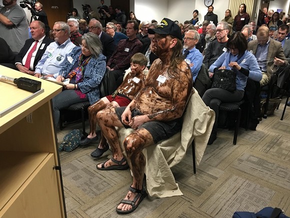 A man and his grandson covered themselves in syrup to protest Enbridge's controversial Line 5 Great Lakes pipeline. - Via Reddit user piscesman