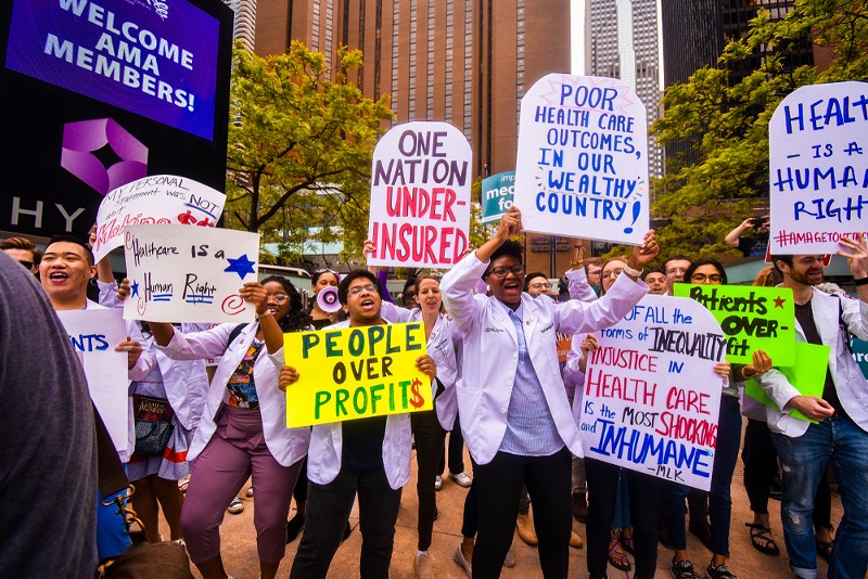 A large group of people gather for the first-ever Medicare For All Rally led by Bernie Sanders in downtown Chicago in 2019. - Shutterstock