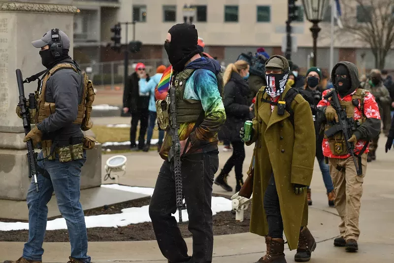 Armed protestors in Lansing support Donald Trump's baseless claims of election fraud. - Lester Graham / Shutterstock.com