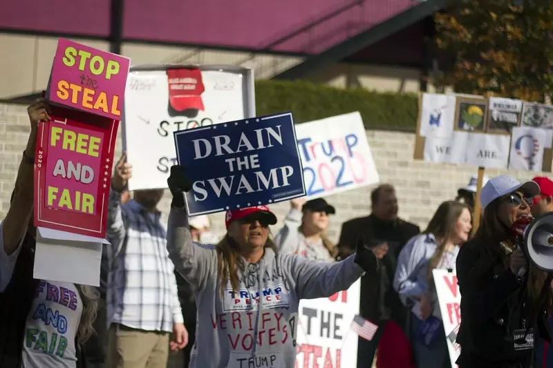 Trump supporters at a "Stop the Steal" rally in Detroit in November 2020. - STEVE NEAVLING