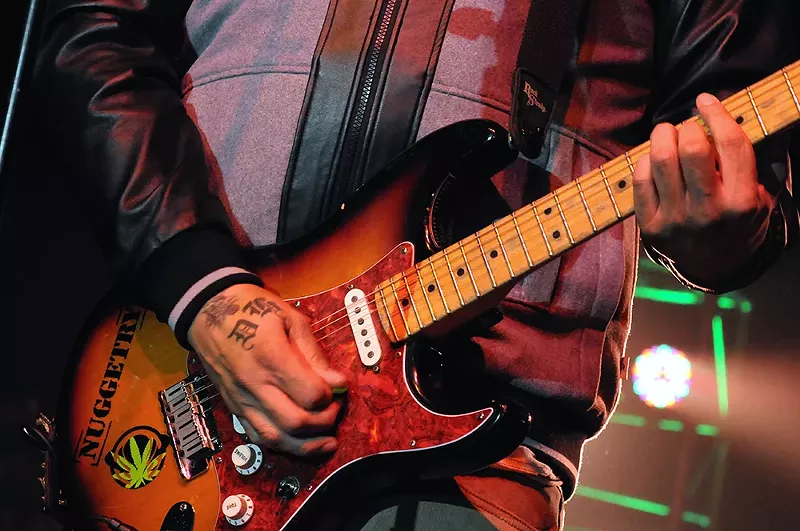 A cannabis sticker on the guitar of Rome Ramirez of the band Sublime with Rome. - Shutterstock