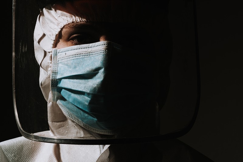 A doctor wearing a mask to protect against COVID-10. - Shutterstock
