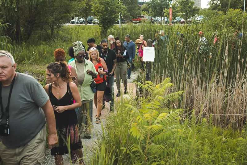 Metro Detroiters on an herb-foraging walk along the Detroit Riverwalk. - Viola Klocko