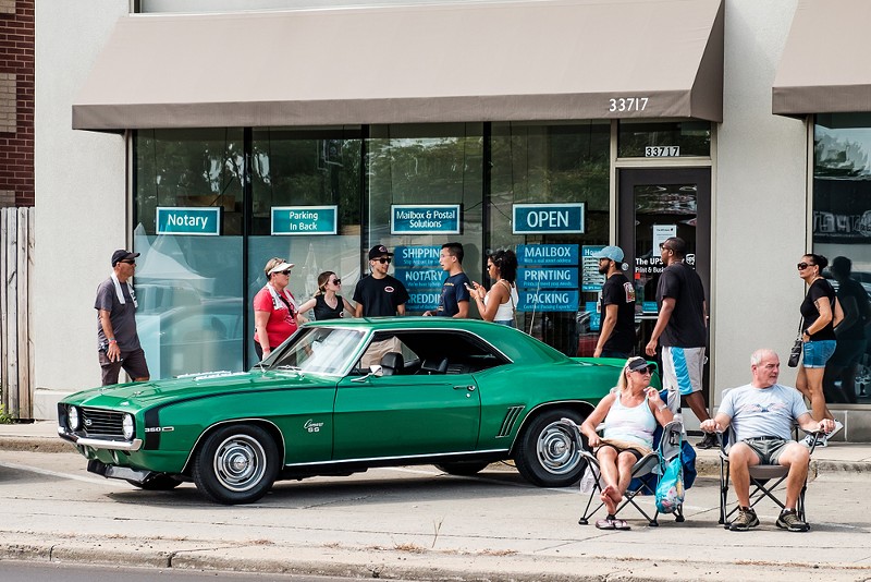 Car fans at the Woodward Dream Cruise. - Shutterstock