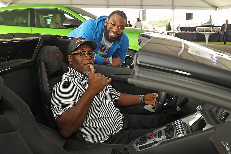 Guests test out a new car at a NAIAS event. - Courtesy photo